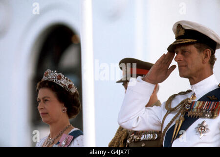 Queen Elizabeth II, and the Duke of Edinburgh watch a march past during a parade of the armed forces after they had attended the State Opening of Parliament in Canberra. Stock Photo