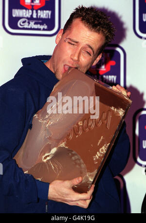 Jason Brown from the boy band Five, who tucked into the largest bar of Cadbury's Dairy Milk chocolate ever made at an MTV Select photocall in London to announce a secret pop event to be staged by the daily pop show later in the year. Stock Photo
