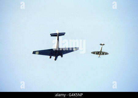 A Junkers Ju 52 (l) is escorted into Biggin Hill airfield by a Spitfire. The German bomber will take it's place among over 200 wartime aircraft at the Biggin Hill International Air Fair this weekend Stock Photo