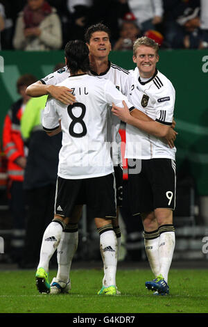 Germany's Mario Gomez celebrates scoring the third goal with teammates Mesut Ozil (l) and Andre Schurrle (r) Stock Photo