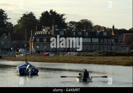 People enjoy a trip in a rowing boat with their dog from the village of Blakeney on the North Norfolk Coast. Stock Photo
