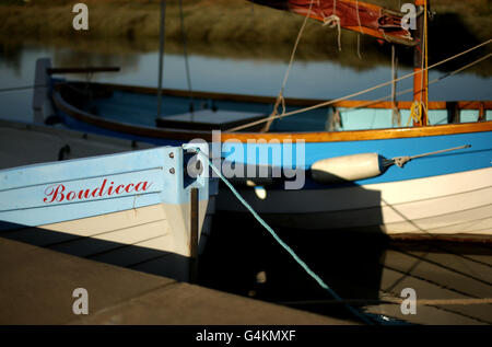 Boats moored on the quayside in the small fishing port village of Blakeney on the North Norfolk Coast. Stock Photo