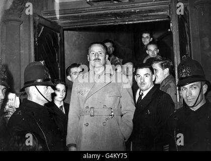 Sir Oswald Mosley, ex leader of the British Union of Fascists, surrounded by police after speaking in public for the first time since the war at the Memorial Hall in Farringdon. Stock Photo