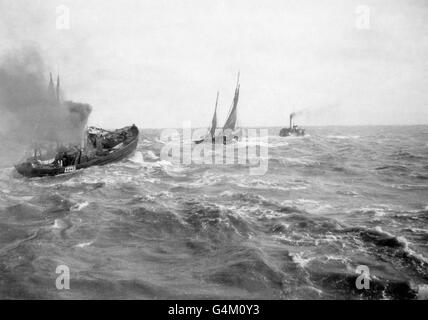 Fishing boats get knocked around in rough waters on the North Sea near the coast of Great Britain Stock Photo