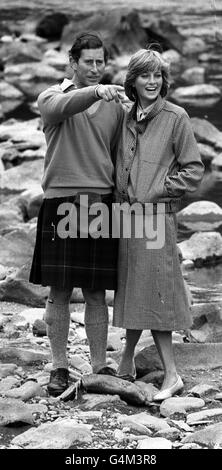 The Prince and Princess Of Wales take a break during their country stroll along the banks of the River Dee, during their holiday at Balmoral Castle where they are staying with The Queen and other members of the Royal Family. Stock Photo