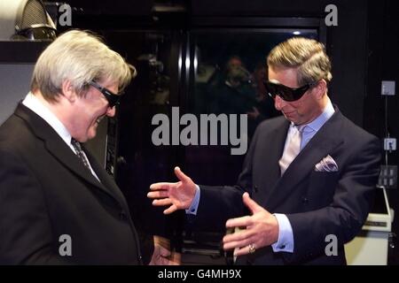 Britain's Prince of Wales (right) and film director Alan Parker wear 3D glasses at the opening Friday June 11, 1999 of the British Film Institute's IMAX cinema in Waterloo, London. The cinema will show 2D and 3D films on a screen which is more than 20 metres high and 26 metres wide. Backed by a 15 million grant from the Arts Council of England s Lottery Fund, the 20 million purpose-built cinema immerses viewers in larger-than-life images and realistic digital sound. Stock Photo