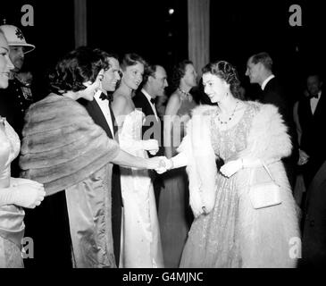 Princess Elizabeth shakes hands with American actress Ava Gardner. Next in line is Ava's husband, singer Frank Sinatra. They were taking part in the Midnight Matinee show at the London Coliseum. Stock Photo