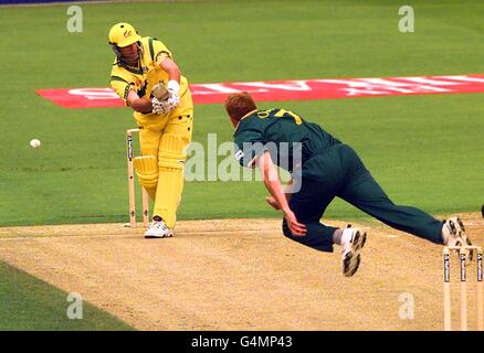 Shaun Pollock of South Africa launches a fierce attack on the Australian batsman Mark Waugh, claiming his wicket in the first over of their 1999 World Cup cricket semi-final match at Edgbaston in Birmingham. Stock Photo