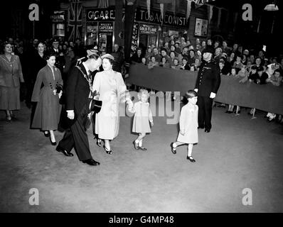 Prince Charles takes the lead on his own while his sister, Princess Anne, holds the hand of the Queen Mother as they leave Portsmouth and Southsea Station. With the royal party is the Lord Mayor of Portsmouth, Alderman Frank Miles. The Royal children were to board the new Royal yacht Britannia to meet their parents in Tobruk, Libya. Stock Photo