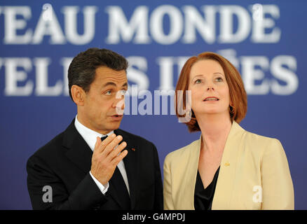 French President Nicolas Sarkozy welcomes Australian Prime Minister Julia Gillard to the G20 Summit in Cannes, France.