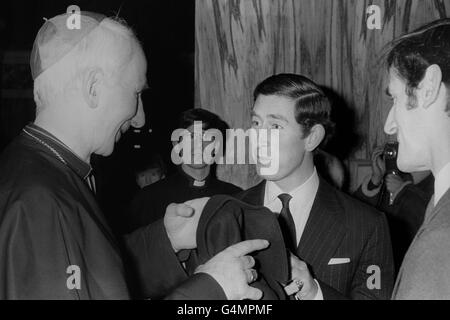 Cardinal Hume, the Roman Catholic Archbishop of Westminster (l) greets the Prince of Wales (r) on arrival at Westminster Cathedral, London, where he attended a Christmas celebration in aid of the Prince's Trust, of which he is president. Stock Photo