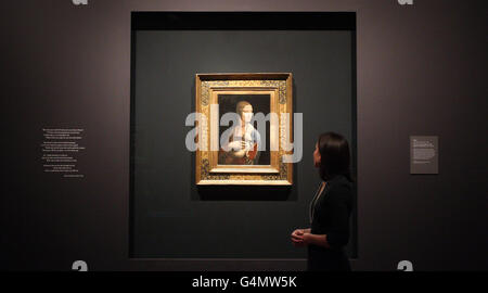 A gallery worker views Leonardo da Vinci's portrait of Cecilia Gallerani entitled 'The Lady with an Ermine' at the National Gallery's landmark exhibition, Leonardo da Vinci: Painter at the Court of Milan. Stock Photo