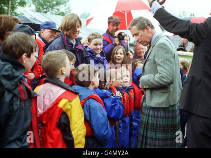 The Prince of Wales, talks to youngsters outside the Glencoe mountain rescue headquarters, during a visit.