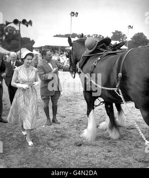 Queen Elizabeth II smiles after presenting rosettes to prizewinners in the Trade and Agricultural Heavy Turnout class at the Royal Windsor Horse Show in the Home Park, Windsor Castle. Stock Photo