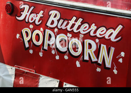 Old Hot Buttered Popcorn sign on concession stand. Canfield Fair. Mahoning County Fair. Canfield, Youngstown, Ohio, USA. Tip of Stock Photo
