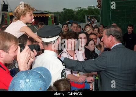 Prince Charles shakes hands with a young girl as he meets members of the public after during the Party in the Park in aid of The Princes Trust in Hyde Park, London. Stock Photo