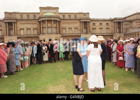 Queen/Garden Party. The Queen talks with guests at a Buckingham Palace garden party. Stock Photo