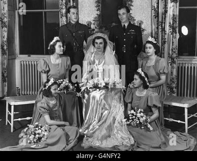 The wedding group at the reception held at Broadlands, the Mountbatten home, shows the bride, Hon. Patricia Mountbatten; and groom, Lord Brabourne; the best man, Squadron leader Charles Harris St. John; and the four bridesmaids, Princess Elizabeth (centre right); Princess Margaret (lower right); Princess Alexandra (lower left); and the Hon. Pamela Mountbatten, sister of the bride. Stock Photo