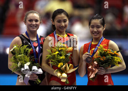 China's He Wenna (centre) with her gold medal, Canada's Rosannagh MacLennan (left) silver medal and China's Li Dan (right) with her bronze medal from the women's individual trampoline final Stock Photo