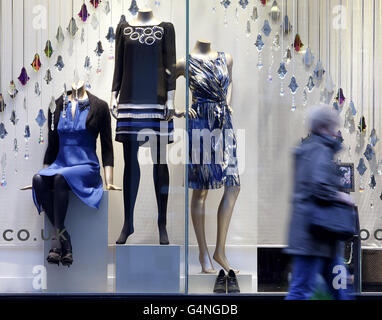A woman walks past a shop on Buchanan Street in Glasgow as the number of people visiting shopping areas has 'nose-dived' according to a Scottish Retail Consortium report. Stock Photo