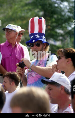 A spectator takes photos whilst wearing an 'Uncle Sam' style hat, during the 1996 Olympic Games in Atlanta. Stock Photo