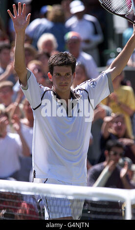 No Commercial Use: British tennis star Tim Henman celebrates after winning his quarter final match against Cedric Pioline of France at Wimbledon. Henman won the match 6-4, 6-2, (4-6) 6-3. Stock Photo