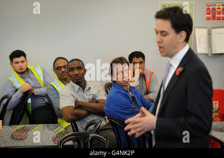 Labour leader Ed Miliband speaks to apprentices and staff at manufacturing firm Kesslers International, who make shop display units in Stratford, east London. Stock Photo