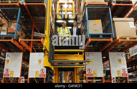 Labour leader Ed Miliband rides on a fork lift at manufacturing firm Kesslers International, who make shop display units in Stratford, east London. Stock Photo
