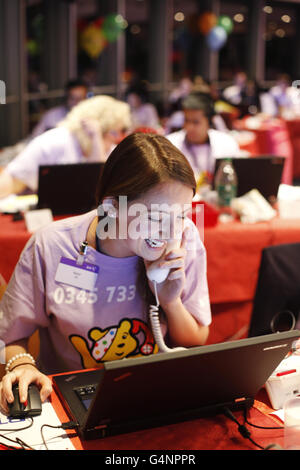 Volunteer Isobel Doherty takes donations at the BT Call Centre in the BT Tower, London during the 31st BBC Children in Need telethon. Stock Photo