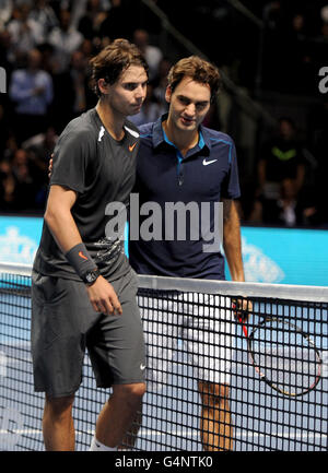 Spain's Rafael Nadal (left) reacts after his defeat to Switzerland's Roger Federer (right) during the Barclays ATP World Tour Finals at the O2 Arena, London. Stock Photo
