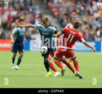 Vancouver, Canada. 18 June, 2016. Vancouver Whitecaps forward Erik Hurtado (19) fighting to keep the ball from New England Revolution midfielder Kelyn Rowe (11). Vancouver Whitecaps vs New England Revolution, BC Place Stadium.  Final Score New England wins 2-1. © Gerry Rousseau/Alamy Live Stock Photo