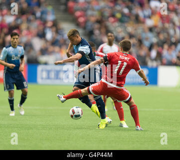 Vancouver, Canada. 18 June, 2016. Vancouver Whitecaps forward Erik Hurtado (19) fighting to keep the ball from New England Revolution midfielder Kelyn Rowe (11). Vancouver Whitecaps vs New England Revolution, BC Place Stadium.  Final Score New England wins 2-1. Credit:  Gerry Rousseau/Alamy Live News Stock Photo