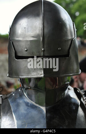 Greenwich, London, UK. 18th June, 2016. A re-enactor dressed as a medieval men at arms during a re-enactment in Greenwich, London, UK. The 'Grand Medieval Joust' was held at Eltham Palace, an English Heritage property which was the home of King Henry VIII as a child. The event aims to give an insight into life at the palace during the medieval period. Credit:  Michael Preston/Alamy Live News Stock Photo