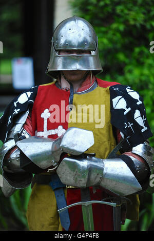 Greenwich, London, UK. 18th June, 2016. A re-enactor dressed as a medieval man at arms during a re-enactment in Greenwich, London, UK. The 'Grand Medieval Joust' was held at Eltham Palace, an English Heritage property which was the home of King Henry VIII as a child. The event aims to give an insight into life at the palace during the medieval period. Credit:  Michael Preston/Alamy Live News Stock Photo