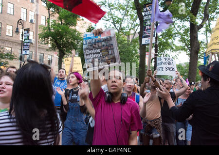 New York, USA. 18th June 2016. Demonstrators rally in front of Stonewall Inn. Members and supporters of the LGBT community rallied at Stonewall Inn in Greenwich Village in solidarity with Orlando after a march from Grand Central Terminal. Credit:  M. Stan Reaves/Alamy Live News Stock Photo