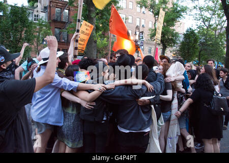 New York, USA. 18th June 2016. Demonstrators embrace during solidarity rally for Orlando. Members and supporters of the LGBT community rallied at Stonewall Inn in Greenwich Village in solidarity with Orlando after a march from Grand Central Terminal. Credit:  M. Stan Reaves/Alamy Live News Stock Photo