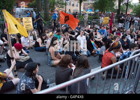 New York, USA. 18th June 2016. Demonstrators observe 10 minutes of silence for the victims of the Orlando massacre. Members and supporters of the LGBT community rallied at Stonewall Inn in Greenwich Village in solidarity with Orlando after a march from Grand Central Terminal. Credit:  M. Stan Reaves/Alamy Live News Stock Photo