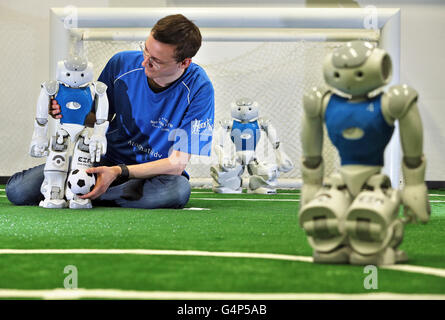 Leipzig, Germany. 31st May, 2016. Hannes Hinerasky of the HTWK team preparing Nao-Robots for a test match on new turf at a lab of the University for Technology and Economy in Leipzig, Germany, 31 May 2016. The team participated in the World Robot Soccer Championship several times. Now they prepare for the 20th RoboCup that will be held in Leipzig between 30 June and 4 July. Roughly 3.5000 participants and 500 teams from 40 countries are expected. PHOTO: JAN WOITAS/dpa/Alamy Live News Stock Photo