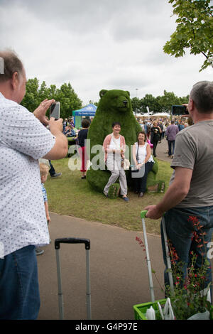 Birmingham, UK. 19th June, 2016. Ladies having their photo taken on a giant bear made of synthetic grass Credit:  steven roe/Alamy Live News Stock Photo