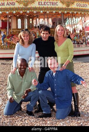 Members of the cast of TV soap EastEnders relax during a break in filming at Brighton. * From left, back: Daniella Morgan - who stars as Sam; Jimi Mistry - Fred Fonseca; Tamzin Outhwaite - Melanie; front: Sylvester Williamson - Mick, and Todd Carty - who plays Mark. Stock Photo