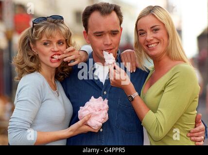 Members of the cast of TV soap EastEnders relax at Brighton during a break. From left: Danniella Morgan, who stars as Sam; Todd Carty, who plays Mark and Tamzin Outhwaite, who plays Melanie . Stock Photo