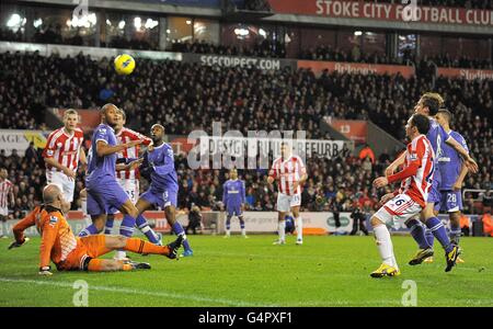 Stoke City's Matthew Etherington (second right) shoots to score his team's second goal as Tottenham Hotspur's goalkeeper Brad Friedel (left) looks on Stock Photo