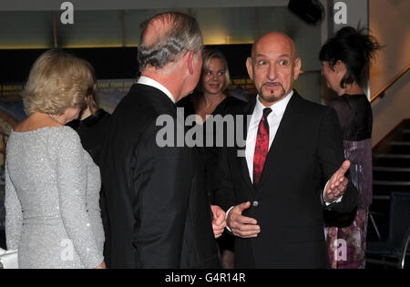 The Prince of Wales meets Sir Ben Kingsley as he and the Duchess of Cornwall attend the Royal Film Performance 2011 of Hugo at the Odeon Cinema in Leicester Square, London. Stock Photo