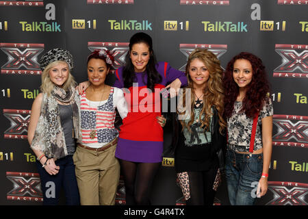 X Factor finalists Perrie Edwards (left), Leigh-Anne Pinnock (second left), Jesy Nelson (second right)and Jade Thirlwall (right) of girl band Little Mix pose with their mentor Tulisa Contostavlos (centre) during photo call ahead of this weekends X Factor Final. Stock Photo