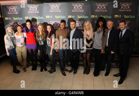 X Factor finalists Perrie Edwards, Leigh-Anne Pinnock , Jesy Nelson and Jade Thirlwall of girl band Little Mix, Marcus Collins and Amelia Lily pose with their mentors Tulisa Contostavlos, Gary Barlow, Kelly Rowland, Louis Walsh and presenter Dermot O'Leary during photo call ahead of this weekends X Factor Final. Stock Photo