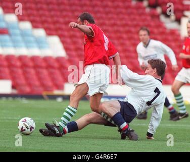 Jim Murphy MP for Eastwood (R), tackles Janos Herbst, at West Ham's Upton Park, during the British Parliamentarian XI v Hungarian Parliamentarian XI football match, a replay of the historic 1953 encounter between England and Hungary. * Present to watch the charity match was was Hungarian football legend Ferenc Puskas who took part in the 2-1 victory over England, in Budapest. Stock Photo