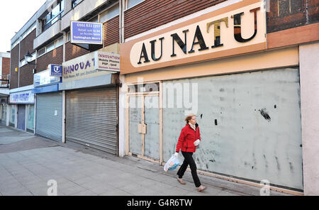 A shopper walks past closed shop fronts in George Street, Altrincham, Cheshire as moves to revitalise high streets and shopping centres struggling to attract customers will be revealed today, including plans for a national market day and relaxation of rules to make it easier to set up street stalls. Stock Photo