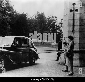 Queen Elizabeth II and the Prince of Wales wave goodbye to Dr. Kwame Nkrumah, Prime Minister of Ghana, at Balmoral Castle, after his one-day visit.