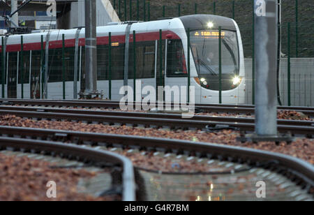 A tram moves along the track during the official handover of the Gogar tram depot in Edinburgh. Stock Photo