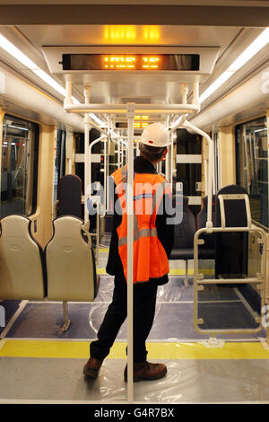 A man looks inside a tram for the first time during the official handover of the Gogar tram depot in Edinburgh. Stock Photo